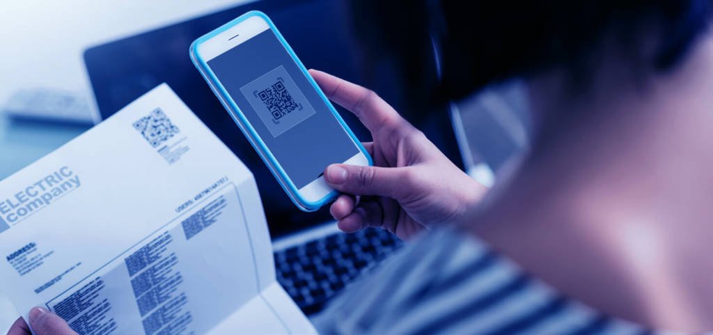 A woman uses a QR code scanner on her phone